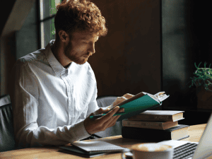 man reading and revising for exams