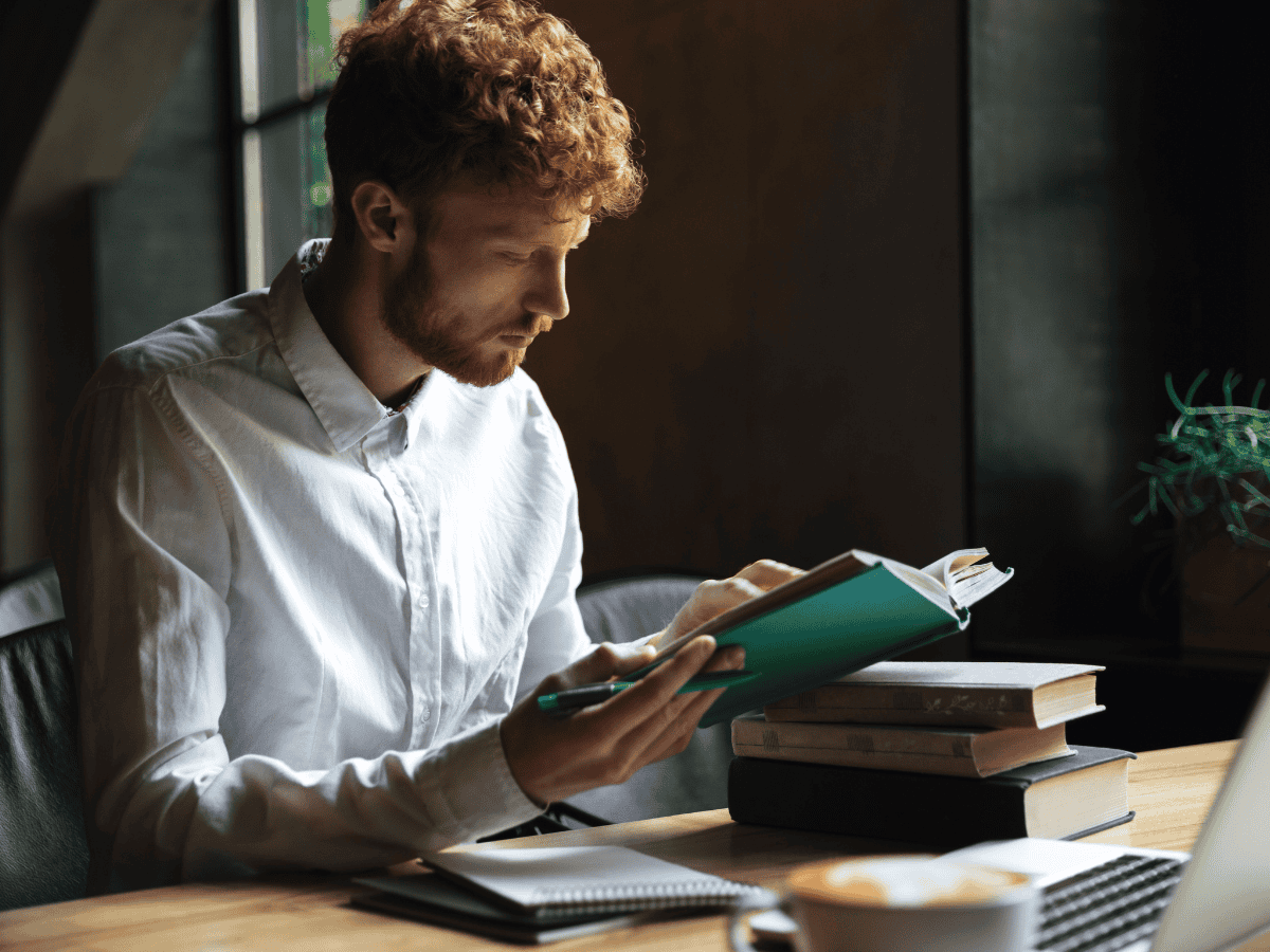 man reading and revising for exams