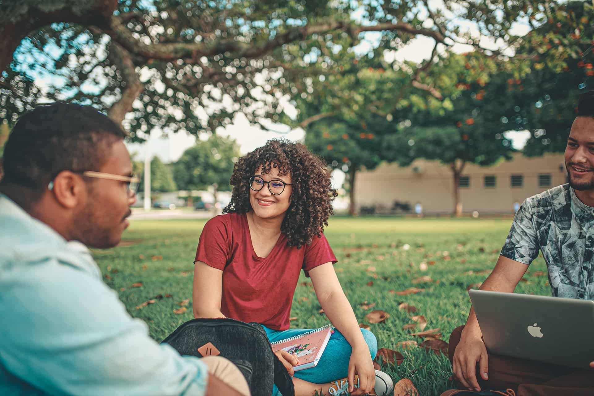 Group of critical thinking students sat outside