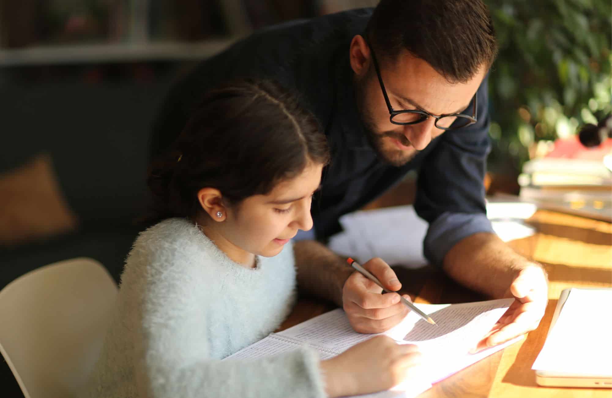 child student and parent learning through distance learning on laptop