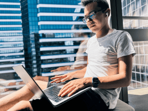 Young male on laptop taking a distance learning GCSE course