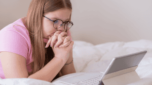 Teenage girl focused on her laptop while studying her online course