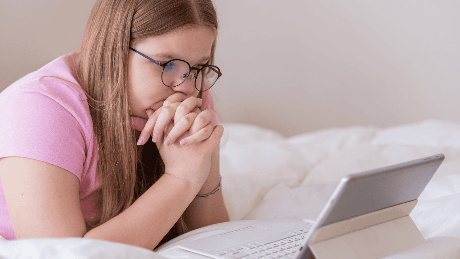 Teenage girl focused on her laptop while studying her online course