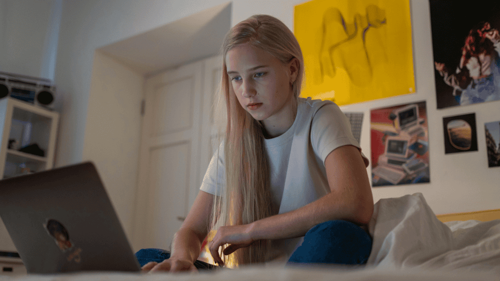 young female on laptop taking gcse resit course
