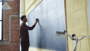 male teacher in classroom education setting since new government manifesto