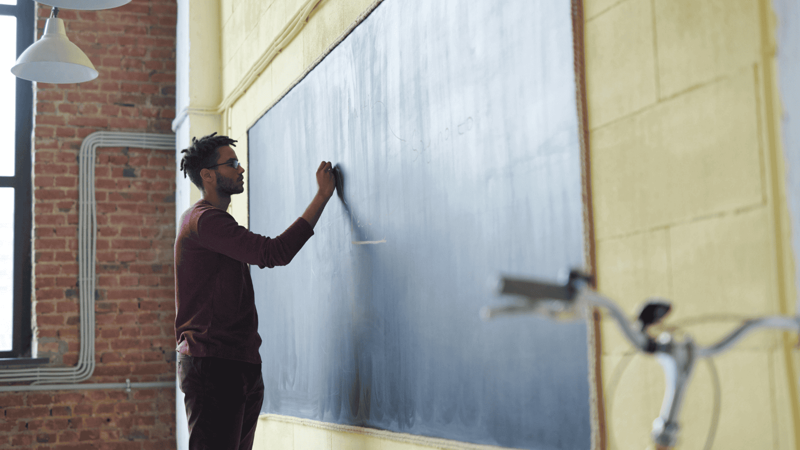 male teacher in classroom education setting since new government manifesto