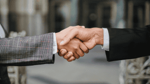 Strong handshake between 2 professionals discussing politics.