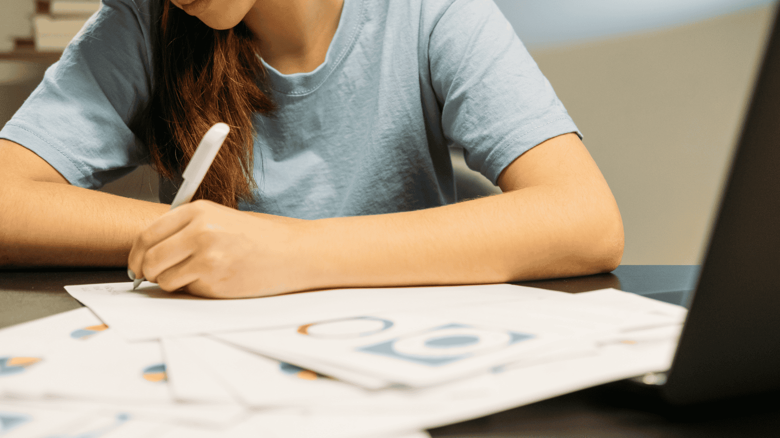 Girl with laptop studying economics.