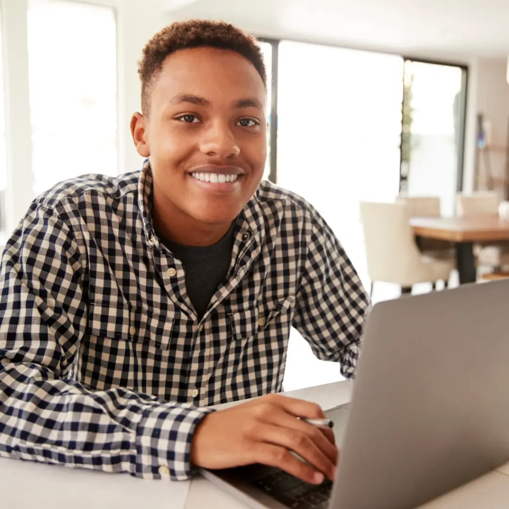 functional skills: smiling man at a desk using a laptop