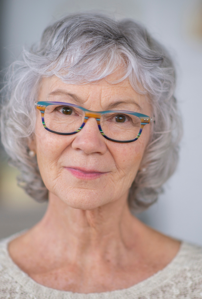 Older lady with glasses looking into camera