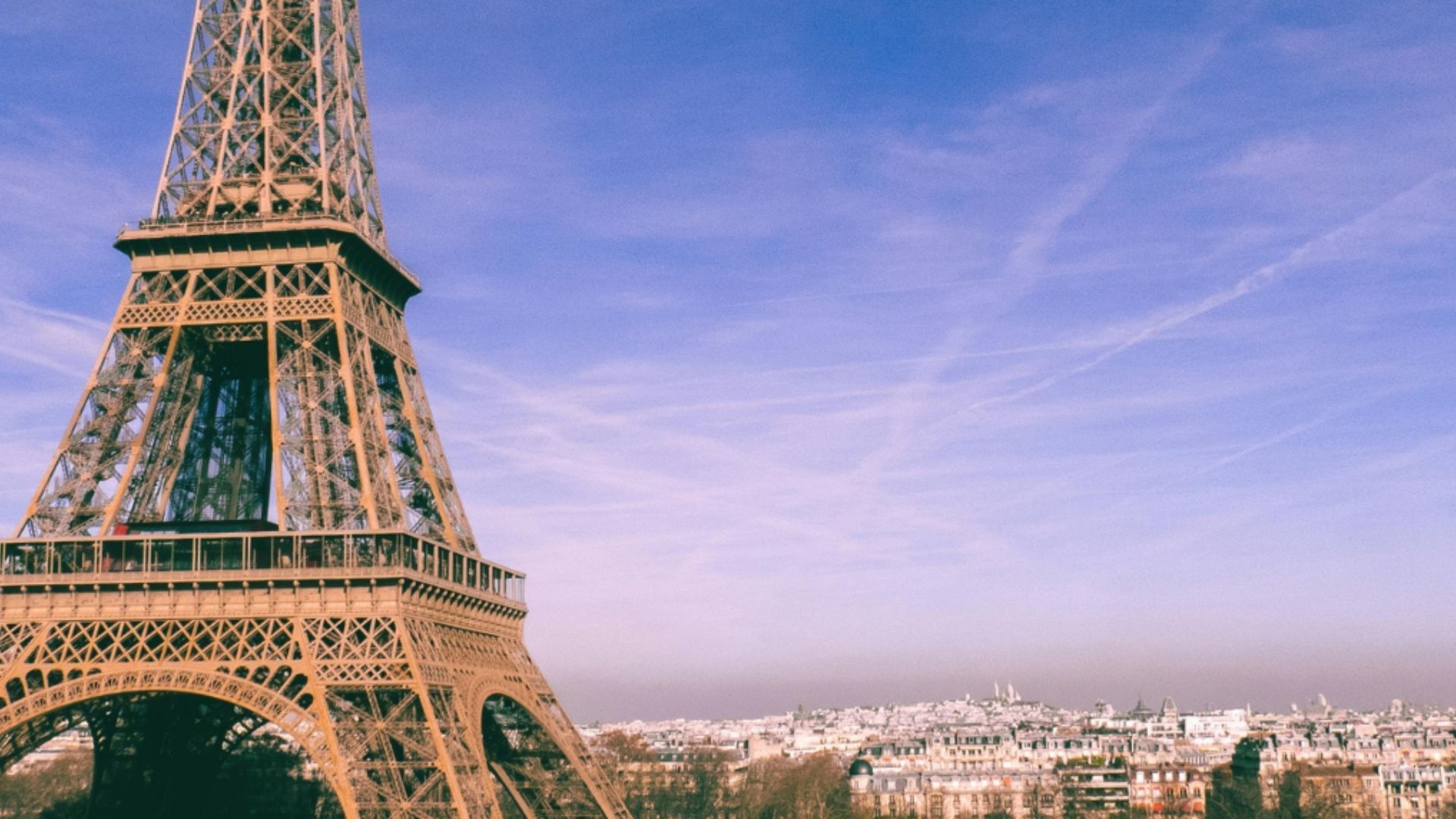 The Eiffel Tower rises above the Paris skyline on a clear day, symbolising French culture, language, and global influence.