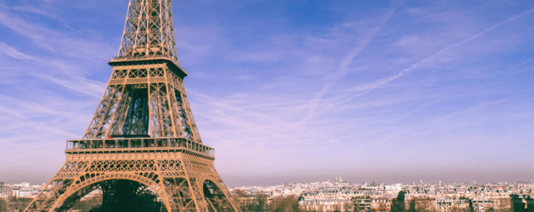 The Eiffel Tower rises above the Paris skyline on a clear day, symbolising French culture, language, and global influence.