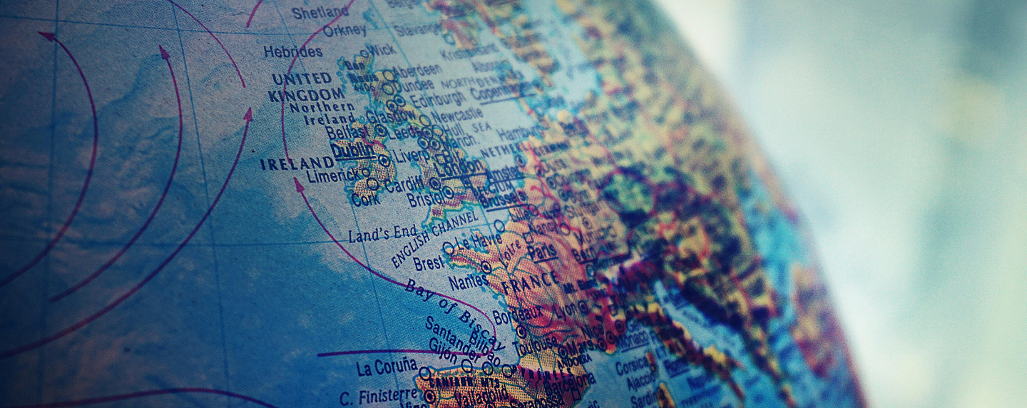 Close-up of a globe focused on the United Kingdom and Western Europe, representing geographical exploration and global awareness.