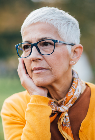 Older female tutor looks wistfully into the distance