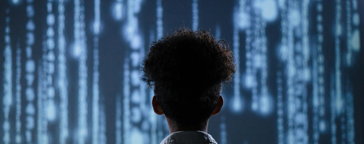 A person looking at a digital screen filled with cascading code, symbolising artificial intelligence and data processing.