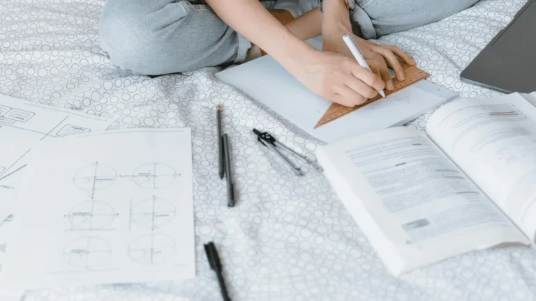 AS level Maths student studying at home on her bed