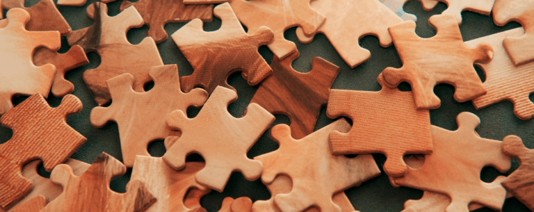 A close-up of scattered puzzle pieces, symbolising the complexity of the human mind and the study of psychology.