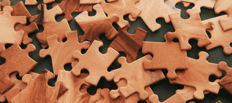 A close-up of scattered puzzle pieces, symbolising the complexity of the human mind and the study of psychology.