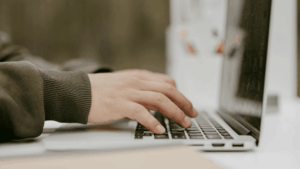 Typing on a laptop