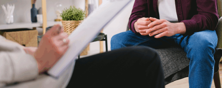 A person sitting in a supportive conversation, illustrating the practical use of counselling skills.
