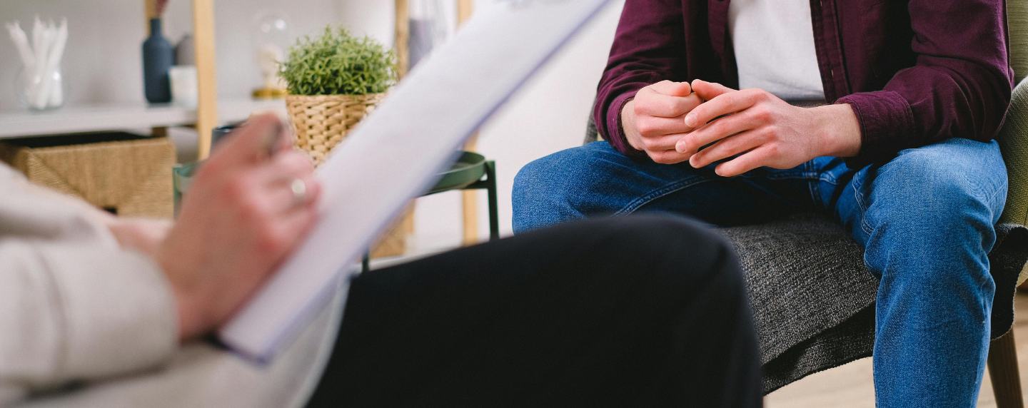 A person sitting in a supportive conversation, illustrating the practical use of counselling skills.