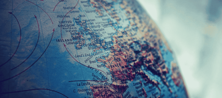 Close-up of a globe focused on the United Kingdom and Western Europe, representing geographical exploration and global awareness.