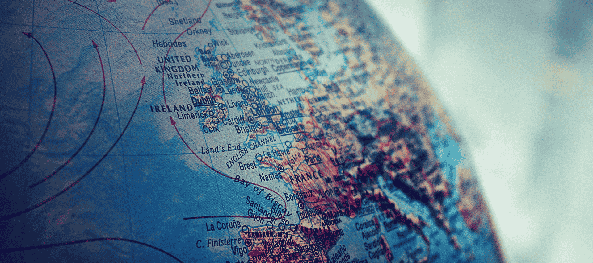 Close-up of a globe focused on the United Kingdom and Western Europe, representing geographical exploration and global awareness.