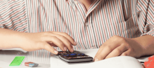 Student sitting at their desk using a calculator