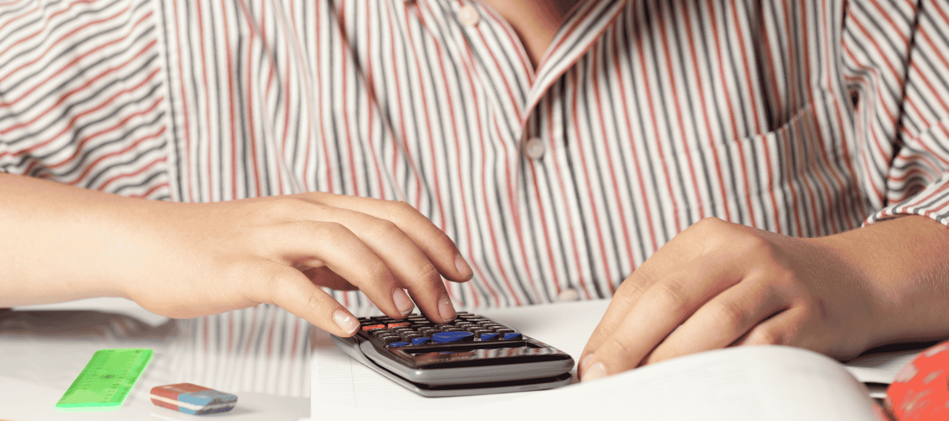 Student sitting at their desk using a calculator