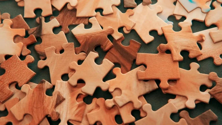 A close-up of scattered puzzle pieces, symbolising the complexity of the human mind and the study of psychology.