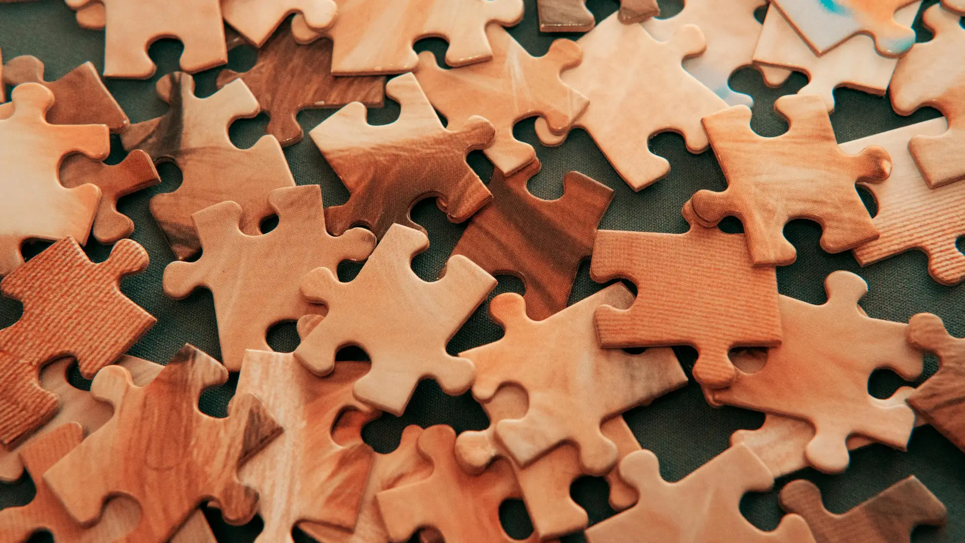 A close-up of scattered puzzle pieces, symbolising the complexity of the human mind and the study of psychology.