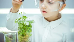 Girl in biology classroom experimenting with a plant!