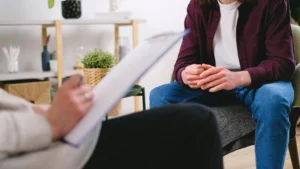 A person sitting in a supportive conversation, illustrating the practical use of counselling skills.