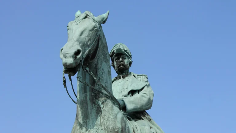 A close-up of a bronze statue of a military figure on horseback, symbolising historical legacy, power, and leadership.
