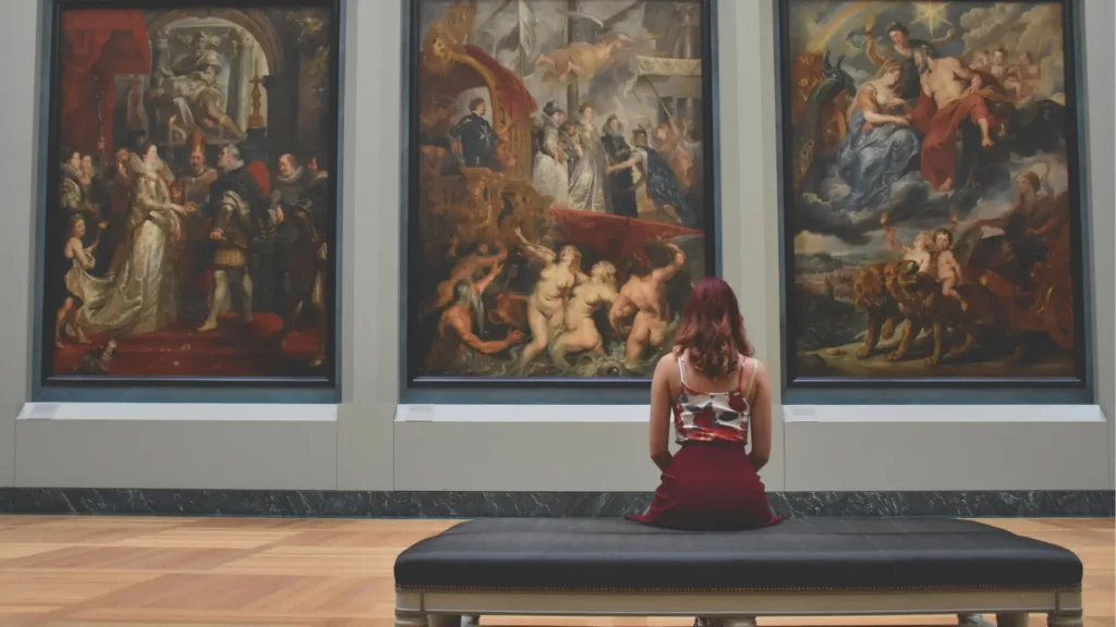young female sitting in gallery looking at art history