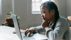 Student studying A levels online with NEC distance learning on a laptop at home.