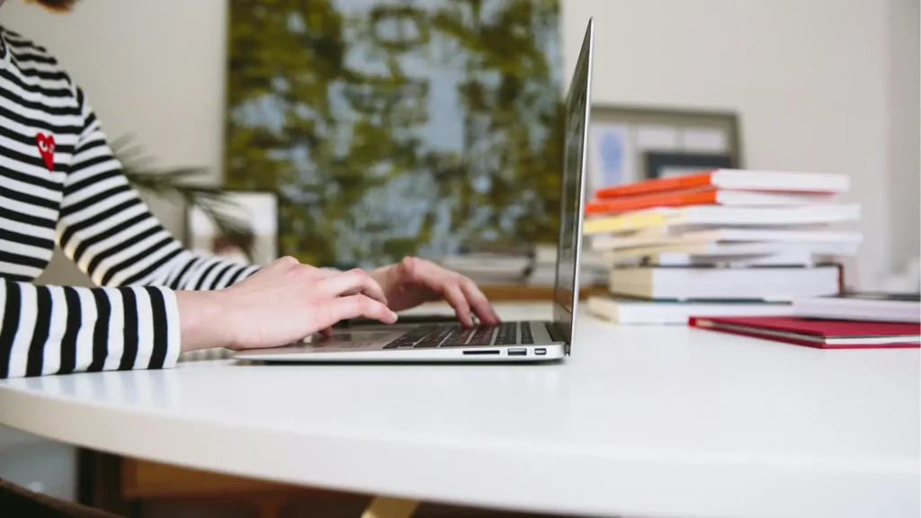 Student studying A levels online with NEC distance learning on a laptop at home.