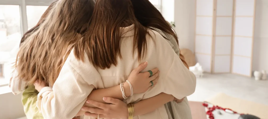 A group of teenage girls hugging