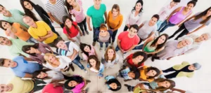 Group of people of all ages looking up at the camera