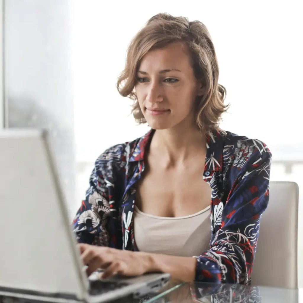 Older learner sat at her laptop.