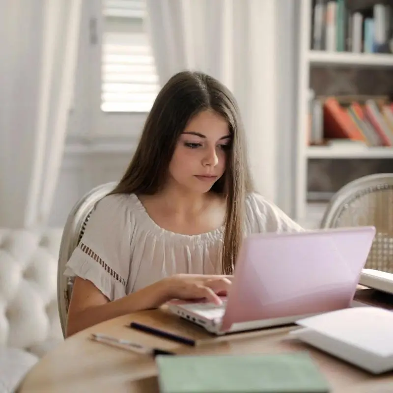 Teen girl working on laptop