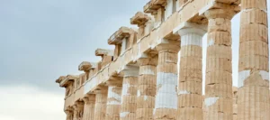 Ancient colonade of pillars against the backdrop of a sunny blue sky