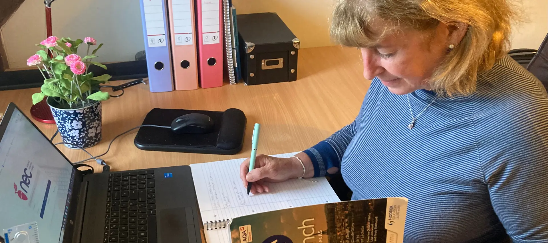Colette at her desk studying her NEC A level French course